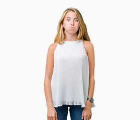 Fototapeta premium Beautiful young elegant woman over isolated background puffing cheeks with funny face. Mouth inflated with air, crazy expression.