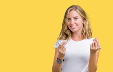 Beautiful young woman wearing casual white t-shirt over isolated background Doing money gesture...