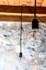 Close up image of a light bulb in a rustic room