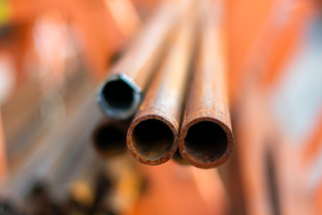 Rusty steel reinforcement bars. Metal warehouse. Iron pipes. Steel rods or bars used to reinforce concrete