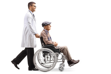 Young male doctor pushing a senior man in a wheelchair