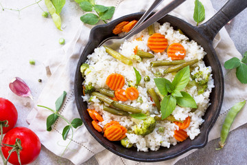 Healthy food: rice with vegetables. Diet vegan menu. Top view flat lay background.