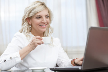 Mature businesswoman working at the hotel room