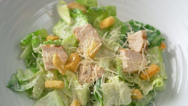 Camera follows putting caesar salad in a plate. Shot with high speed camera, phantom flex 4K. Slow Motion.