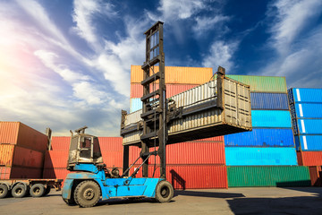 Forklift container loading and unloading cargo into the import-export zone