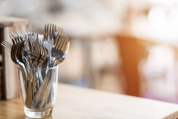 Many fork are placed with In the glass on the dining table decoration in hotel