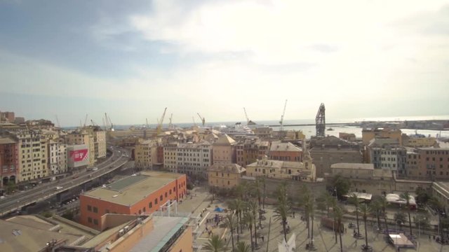 Aerial view of Geona (Genova) from bigo, the rotating panoramic tower over the celebrated acquarium. You can see cars traveling, the harbourd and the city.