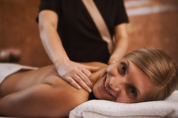 Obraz na płótnie Canvas Mature woman getting massage at the spa