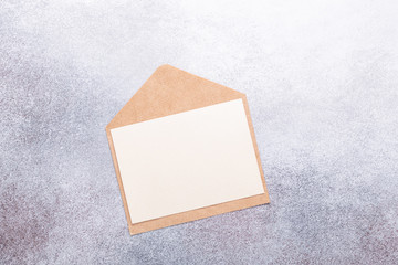 Blank paper with envelope on grey background