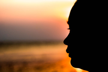 Silhouette of a girl face in the evening