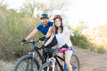 Couple of cyclists riding bikes and exploring some trails outdoor
