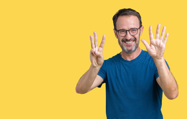 Handsome middle age hoary senior man wearin glasses over isolated background showing and pointing up with fingers number eight while smiling confident and happy.