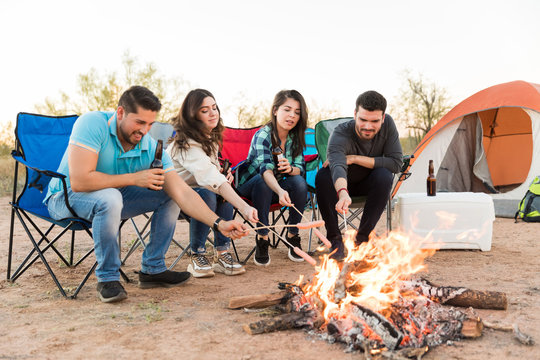 Cooking Hot Dog Sausages Over Camp Fire - Powered by Adobe
