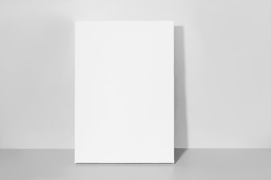 Blank canvas, gray wall on background. Mockup poster.