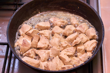 Slices of meat fried in a pan