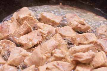 Slices of meat fried in a pan