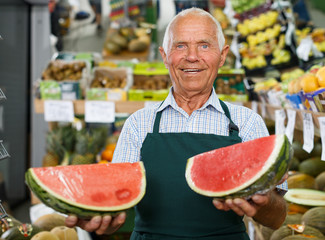 Seller proffering fruits and vegetables