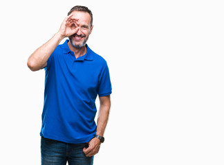 Middle age hoary senior man over isolated background doing ok gesture with hand smiling, eye looking through fingers with happy face.