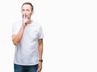 Middle age hoary senior man wearing white t-shirt over isolated background asking to be quiet with finger on lips. Silence and secret concept.