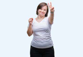 Young adult woman with down syndrome over isolated background smiling with happy face winking at the camera doing victory sign. Number two.