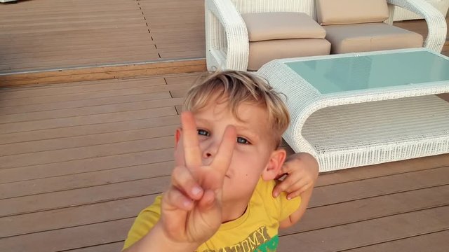 Laughing Kid showing Victory Sign