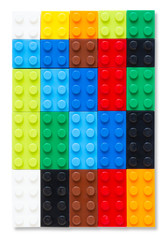 Multi-colored plastic building block on white background