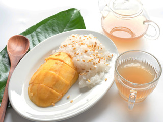 Mango and sticky rice in a dish, a glass of herbal isolated white background.