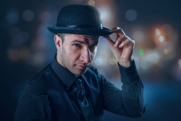 Sharp dressed man. Urban male portrait with outdoor lights as background