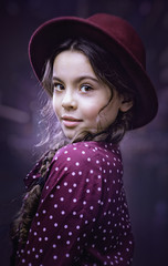 Urban female portrait. Beauty young girl turned around and looking at camera