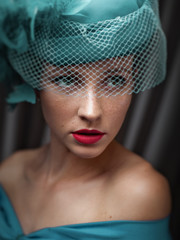 Female portrait behind the veil. Retro styled woman looking away