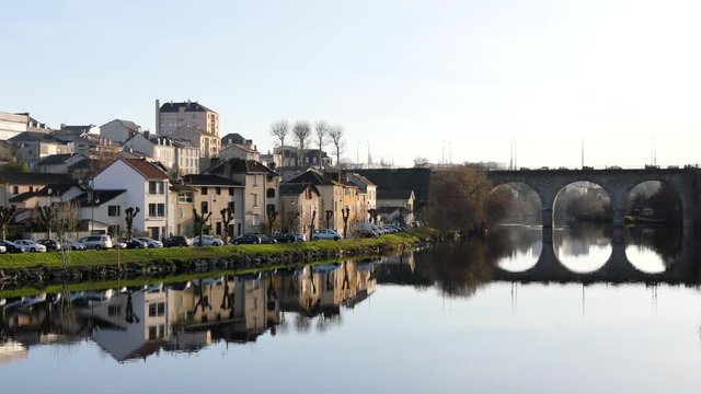 Famous view of Limoges a city in central west france. Reflection on the water. River banks. The river is the Vienne. The bridge in the background is called "Pont de la r&eacute;volution" in french. 