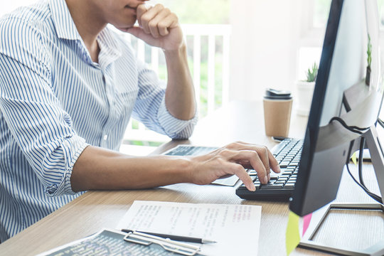 Professional programmer working at developing programming and website working in a software develop company office, writing codes and typing data code