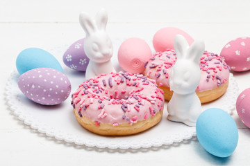Easter Eggs Over Wooden Background with bunnies