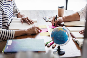 Tutor books with friends, Young students campus or classmates helps friend catching up workbook and learning tutoring in classroom practice preparing exam to entrance, Education school concept