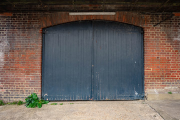 old wooden door in brick wall