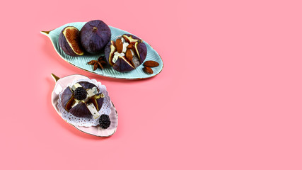 Delicious dessert made with figs fruit, cheese and honey living coral background. Top view. Copy space