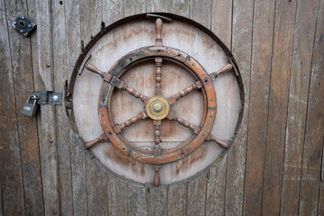 old wooden door with  steering wheel