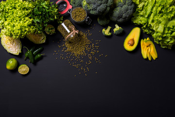 Healthy vegetables and fruits on black background. Detox diet. Different colorful fresh vegan food....