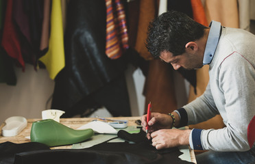 Shoemaker cutting leather