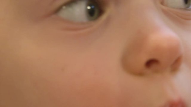 Extreme close up of a little girl enjoying a homemade sprinkle cookie