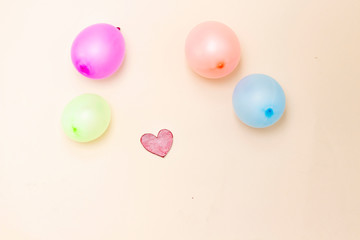  red heart and colorful balloon  on wood table