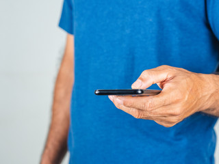 Closeup of young man using smartphone isolated on a white background