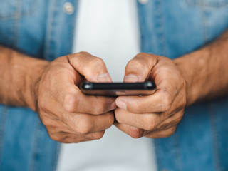 Closeup of young man using smartphone isolated on a white background