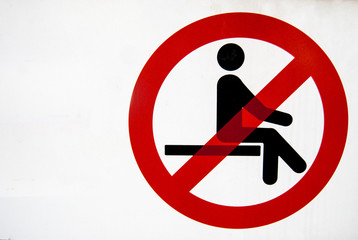 Prohibition sign to sit down with white background