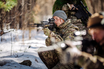 team of special forces weapons in cold forest. Winter warfare and military concept