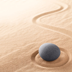 Fototapeta na wymiar Spa wellness for inner life therapy and spiritual health. Zen meditation stone for relaxation. Concept for purity balance and harmony. Background with raked sand.
