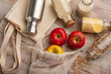 Natural, plastic free recycled textile produce bag for carrying fruit or vegetables on a wooden...