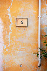 orange painted wall with the number six