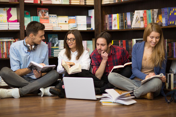 Gorup of college friends studying together at the library