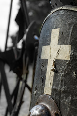 Medieval shield for defence and protection, made of grey leather and fabric, decorated with a cross